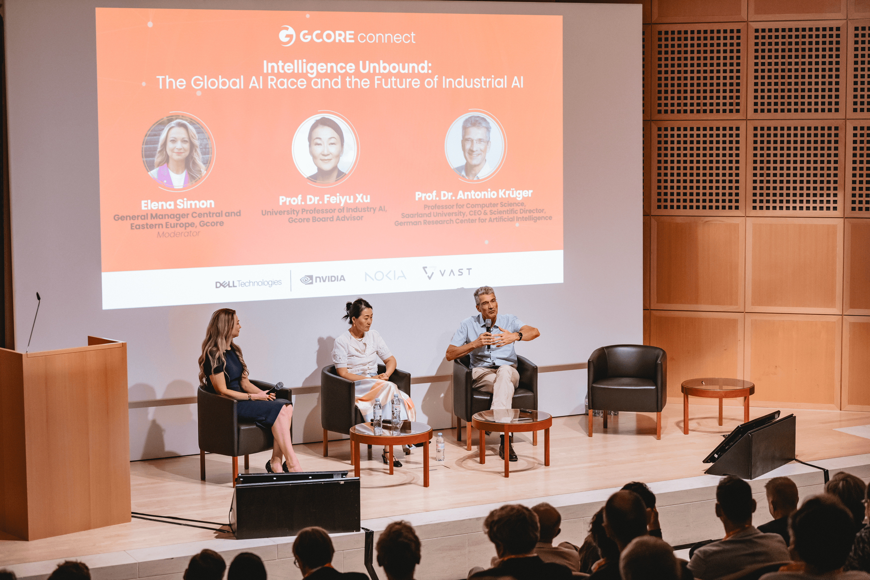 Panelists discuss 'The Global AI Race and Industrial AI' on stage to an audience.